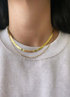 Herringbone gold chain necklace styled with gold paperclip necklace