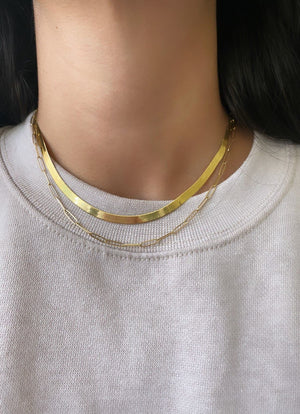 Herringbone gold chain necklace styled with gold paperclip necklace